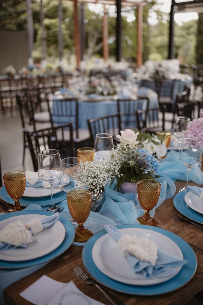 The Art of Drawing Readers In: Your attractive post title goes here Beautifully decorated outdoor wedding reception table with blue theme and floral centerpiece.